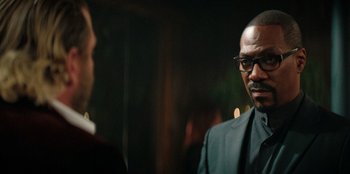 Movie still from “You People” (2023), directed by Kenya Barris – A man wearing a suit and tie talking to another man; Close Up shot, Over the shoulder angle