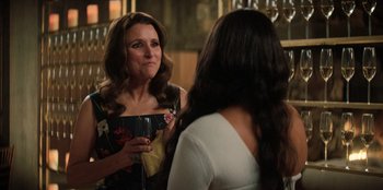 Movie still from “You People” (2023), directed by Kenya Barris – Two women standing in front of each other holding wine glasses; Close Up shot, Over the shoulder angle