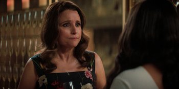 Movie still from “You People” (2023), directed by Kenya Barris – A person sitting in a room holding a wine glass; Close Up shot, Over the shoulder angle