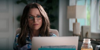 Movie still from “You People” (2023), directed by Kenya Barris – A woman sitting in front of a laptop computer; Close Up shot, Over the shoulder angle