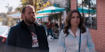 Movie still from “You People” (2023), directed by Kenya Barris – A man and a woman standing next to each other on the sidewalk; Medium shot, Over the shoulder angle