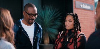Movie still from “You People” (2023), directed by Kenya Barris – A man and a woman standing next to each other; Medium shot, Over the shoulder angle