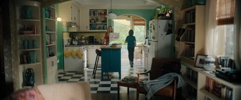 Movie still from “Your Place or Mine” (2023), directed by Aline Brosh McKenna – Two people in a kitchen looking out a window; Wide shot, High angle