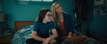 Movie still from “Your Place or Mine” (2023), directed by Aline Brosh McKenna – Two people sitting on a bed in a room; Medium shot, Over the shoulder angle