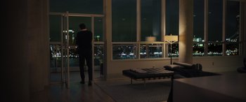 Movie still from “Your Place or Mine” (2023), directed by Aline Brosh McKenna – A man standing in front of a window at night; Extreme Wide shot, High angle