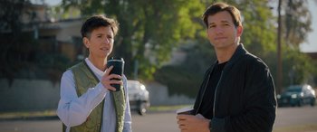 Movie still from “Your Place or Mine” (2023), directed by Aline Brosh McKenna – A woman and a man standing next to each other on the side of the road; Medium shot, Over the shoulder angle