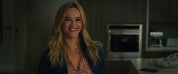 Movie still from “Your Place or Mine” (2023), directed by Aline Brosh McKenna – A woman smiling for the camera in front of an oven; Close Up shot, Over the shoulder angle