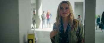 Movie still from “Your Place or Mine” (2023), directed by Aline Brosh McKenna – A woman standing next to a group of people in a building; Medium shot, Over the shoulder angle