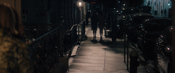 Movie still from “Your Place or Mine” (2023), directed by Aline Brosh McKenna – Two people walking down a sidewalk at night; Wide shot, Over the shoulder angle