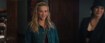 Movie still from “Your Place or Mine” (2023), directed by Aline Brosh McKenna – A woman with long blonde hair smiles for the camera; Close Up shot, Over the shoulder angle