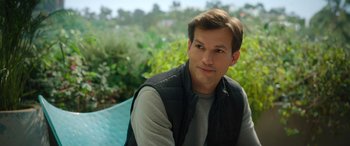Movie still from “Your Place or Mine” (2023), directed by Aline Brosh McKenna – A man sitting on a bench in a park; Close Up shot, Over the shoulder angle