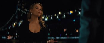 Movie still from “Your Place or Mine” (2023), directed by Aline Brosh McKenna – A beautiful young woman standing in front of lights; Medium shot, Over the shoulder angle