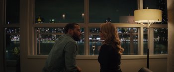 Movie still from “Your Place or Mine” (2023), directed by Aline Brosh McKenna – A man and a woman talking in front of a window at night; Medium shot, Over the shoulder angle