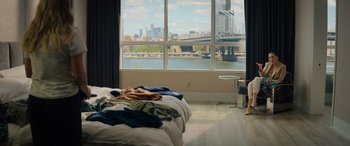 Movie still from “Your Place or Mine” (2023), directed by Aline Brosh McKenna – A bedroom with a view of a city and a bridge; Wide shot, High angle