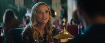 Movie still from “Your Place or Mine” (2023), directed by Aline Brosh McKenna – A person sitting at a table in a room; Close Up shot, Over the shoulder angle