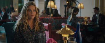 Movie still from “Your Place or Mine” (2023), directed by Aline Brosh McKenna – A woman sitting at a table in a restaurant; Medium shot, Over the shoulder angle