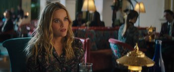 Movie still from “Your Place or Mine” (2023), directed by Aline Brosh McKenna – A beautiful young lady sitting at a table in a restaurant; Close Up shot, Over the shoulder angle