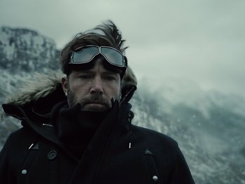 Movie still from “Zack Snyder's Justice League” (2021), directed by Zack Snyder – A person wearing goggles and a jacket; Close Up shot, Low angle