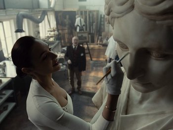 Movie still from “Zack Snyder's Justice League” (2021), directed by Zack Snyder – A woman is painting a statue in a room; Close Up shot, Over the shoulder angle