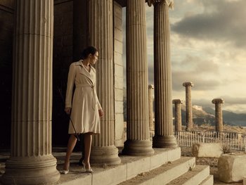 Movie still from “Zack Snyder's Justice League” (2021), directed by Zack Snyder – A woman standing on steps near a building; Extreme Wide shot, Low angle
