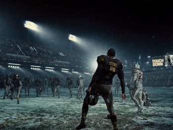 Movie still from “Zack Snyder's Justice League” (2021), directed by Zack Snyder – A group of football players are playing a game in the snow; Extreme Wide shot, Low angle