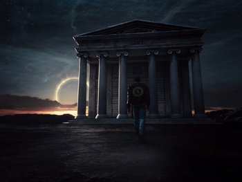 Movie still from “Zack Snyder's Justice League” (2021), directed by Zack Snyder – A man is standing in front of a building; Extreme Wide shot, Low angle