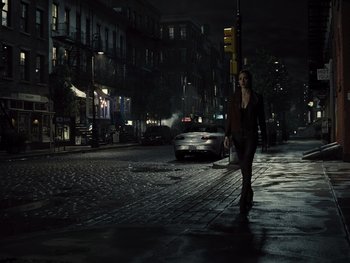 Movie still from “Zack Snyder's Justice League” (2021), directed by Zack Snyder – A woman walking down a street at night; Wide shot, High angle