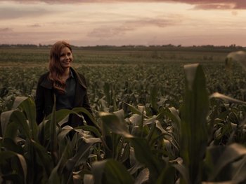 Movie still from “Zack Snyder's Justice League” (2021), directed by Zack Snyder – A woman standing in a corn field at sunset; Wide shot, Low angle