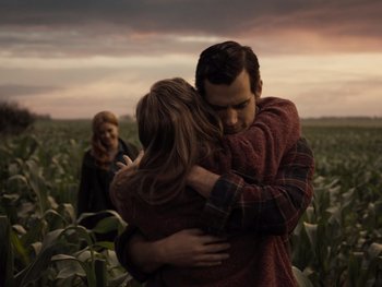 Movie still from “Zack Snyder's Justice League” (2021), directed by Zack Snyder – A man and a woman hugging in a field; Medium shot, Over the shoulder angle