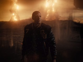 Movie still from “Zack Snyder's Justice League” (2021), directed by Zack Snyder – A man standing in front of a wall of fire; Medium shot, Low angle