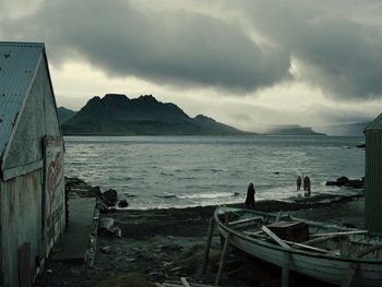 Movie still from “Zack Snyder's Justice League” (2021), directed by Zack Snyder – A person standing next to a body of water; Extreme Wide shot, Low angle
