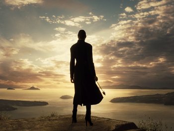 Movie still from “Zack Snyder's Justice League” (2021), directed by Zack Snyder – A woman standing on a cliff looking out at the ocean; Extreme Wide shot, Low angle