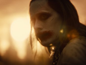 Movie still from “Zack Snyder's Justice League” (2021), directed by Zack Snyder – A person wearing a joker mask; Extreme Close Up shot, Over the shoulder angle