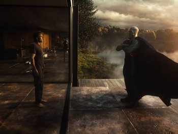 Movie still from “Zack Snyder's Justice League” (2021), directed by Zack Snyder – A man standing in front of another man in a black suit; Wide shot, Over the shoulder angle