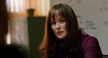 Movie still from “Zero Dark Thirty” (2012), directed by Kathryn Bigelow – A person with long brown hair; Close Up shot, Over the shoulder angle