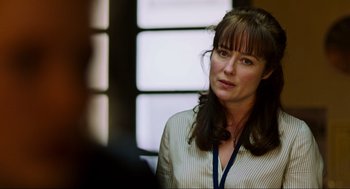 Movie still from “Zero Dark Thirty” (2012), directed by Kathryn Bigelow – A woman in a white shirt is standing in front of a window; Close Up shot, Over the shoulder angle