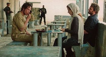 Movie still from “Zero Dark Thirty” (2012), directed by Kathryn Bigelow – A man and a woman are sitting at a table; Medium shot, Over the shoulder angle