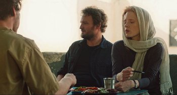 Movie still from “Zero Dark Thirty” (2012), directed by Kathryn Bigelow – A group of people sitting at a table eating food; Medium shot, Over the shoulder angle
