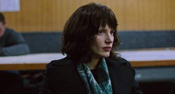 Movie still from “Zero Dark Thirty” (2012), directed by Kathryn Bigelow – A woman in a black jacket and a green scarf; Close Up shot, High angle