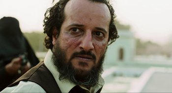 Movie still from “Zero Dark Thirty” (2012), directed by Kathryn Bigelow – A person wearing a suit and tie; Close Up shot, Low angle