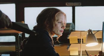Movie still from “Zero Dark Thirty” (2012), directed by Kathryn Bigelow – A woman sitting in front of a bunch of post it notes; Close Up shot, Low angle