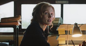 Movie still from “Zero Dark Thirty” (2012), directed by Kathryn Bigelow – A woman sitting in front of a bunch of papers; Close Up shot, Low angle