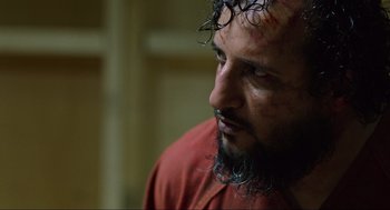 Movie still from “Zero Dark Thirty” (2012), directed by Kathryn Bigelow – A person wearing a red shirt; Close Up shot, Over the shoulder angle