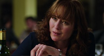 Movie still from “Zero Dark Thirty” (2012), directed by Kathryn Bigelow – A person wearing a necklace; Close Up shot, Over the shoulder angle