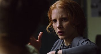 Movie still from “Zero Dark Thirty” (2012), directed by Kathryn Bigelow – A woman with red hair is talking to someone; Close Up shot, Over the shoulder angle