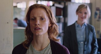 Movie still from “Zero Dark Thirty” (2012), directed by Kathryn Bigelow – A woman with red hair is standing in front of a man; Medium shot, Over the shoulder angle