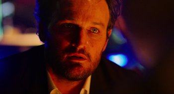 Movie still from “Zero Dark Thirty” (2012), directed by Kathryn Bigelow – A person wearing a suit and tie; Close Up shot, Low angle