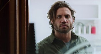 Movie still from “Zero Dark Thirty” (2012), directed by Kathryn Bigelow – A person with long hair and a beard; Close Up shot, Over the shoulder angle