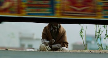 Movie still from “Zero Dark Thirty” (2012), directed by Kathryn Bigelow – A man sitting on the side of a road; Wide shot, Low angle