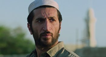 Movie still from “Zero Dark Thirty” (2012), directed by Kathryn Bigelow – A person wearing a hat; Close Up shot, Low angle